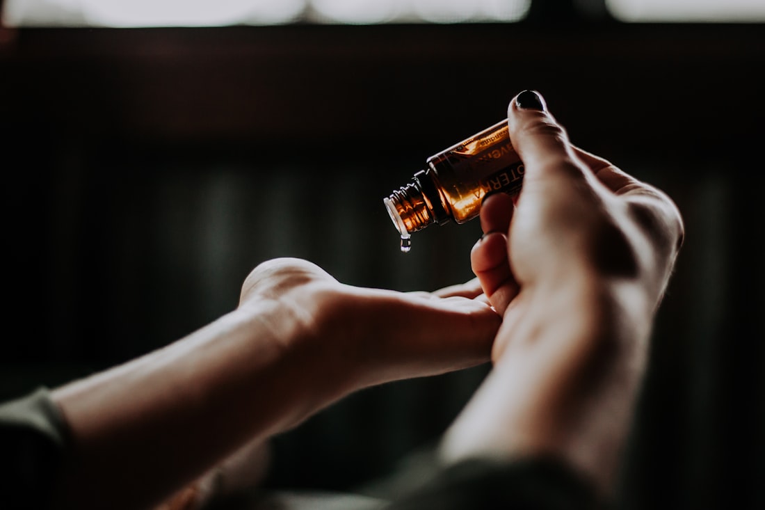 Massage oils and warm details on a wooden tray